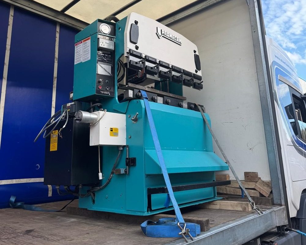 A single machine being collected. On the lorry or going up the ramp, one item not a whole shop.