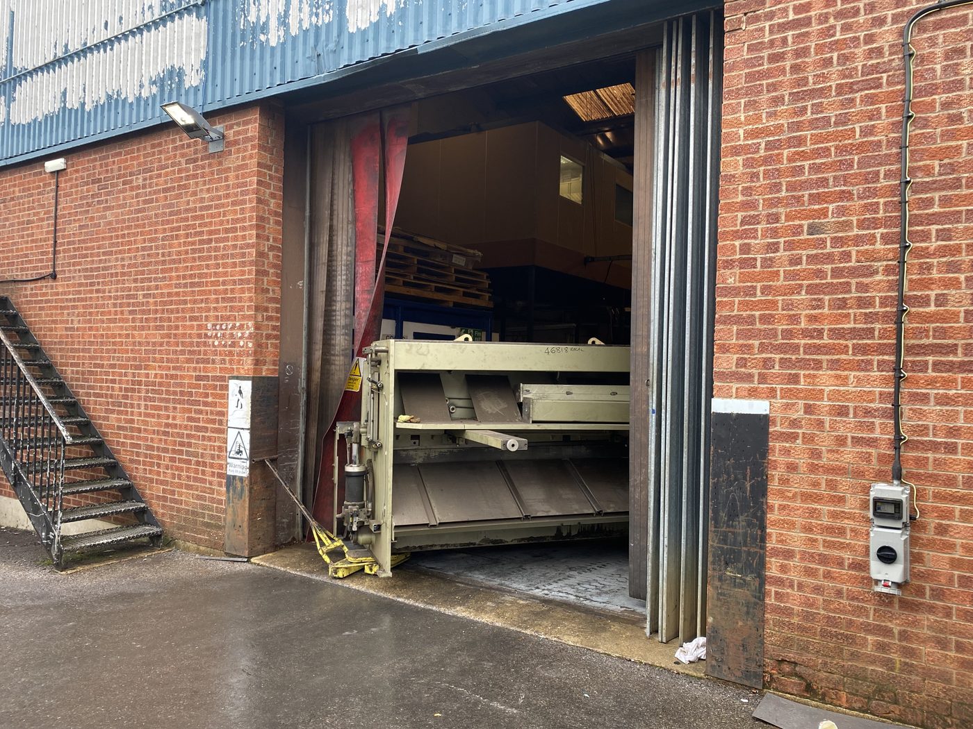 A machine on skates or rollers going through a doorway or down a gangway, tight to the walls.